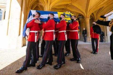 PA Media The Duke of Edinburgh's coffin, covered with his Personal Standard, is carried to the purpose built Land Rover Defender ahead of the funeral of the Duke of Edinburgh in Windsor Castle, Berkshire. Picture date: Saturday April 17, 2021