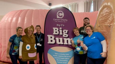 Members of the Big C Cancer Charity in front of an inflatable bum