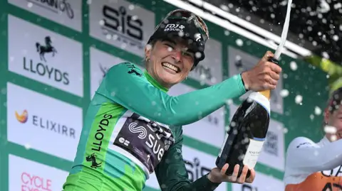 Ally Wollaston celebrates on the podium