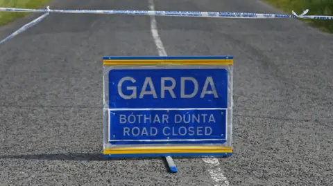 A blue Garda road closed sign.
