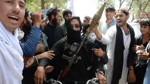 AFP/Getty militant and residents in Jalalabad