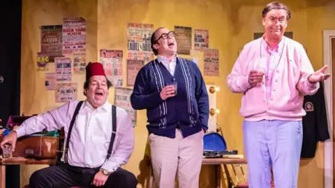 Pamela Raith Photography Damian Williams as Tommy Cooper, Bob Golding as Morecambe and Simon Cartwright as Monkhouse in The Last Laugh