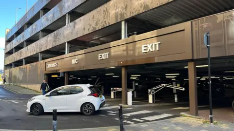 A car leaving Piries place car park in Horsham - the car park with the largest price increase