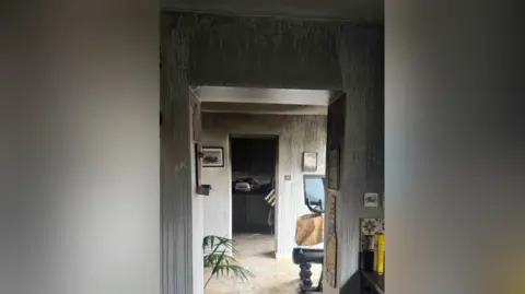 Kaela Rigg Image shows walls streaked due to effects of smoke within corridor at Kaela's home. 