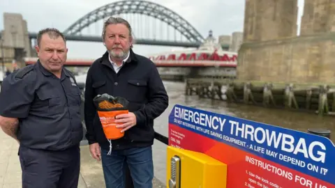 TWFRS Tommy Richardson (left) from TWFRS and Nick Pope (right) holding one of the new throw bags on Quayside