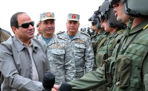 Getty Images Egypt's President Sisi (L) meeting pilots working at military base near the border with Libya - 18 February 2015