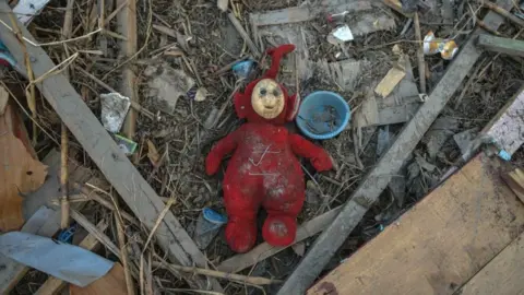 Getty Images Childrens toys in the rubble of houses