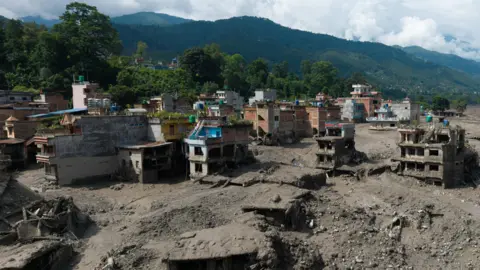 Reuters A drone view shows mud covering properties following a flash flood at Trishuli in Nuwakot district, Nepal, August 26, 2026