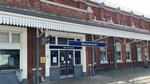 Entrance of Bournemouth railway station showing doors and sign above