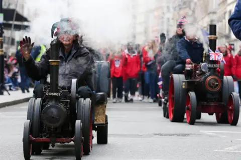 Getty Images Performers are seen on ancient vehicles during London New Year's Day parade