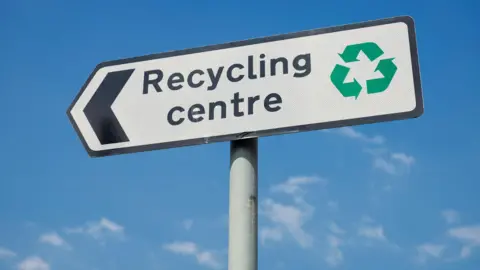 Getty Images A generic photo of a recycling centre sign against a blue sky.