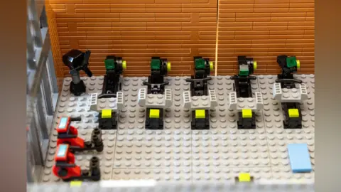 David Johnson Photographic Part of a Lego model shows little rowing machines.