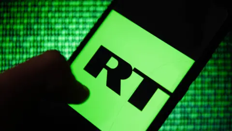 RT logo on smartphone on green data background.