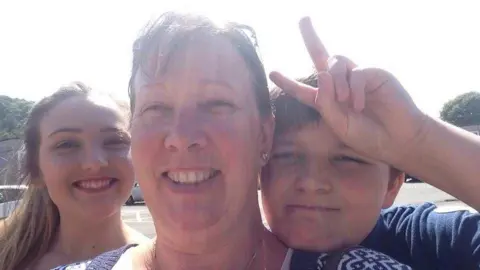 Chloe Cooper Selfie of Chloe with Cheryl and Ethan on a sunny day. All three are smiling looking at the camera. 
