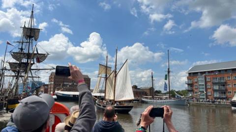 Visitors photographing ships in Gloucester docks