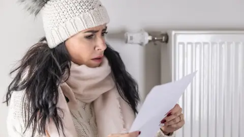 Getty Images Woman looking at energy bill