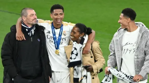 AFP/Getty Images Father Mark (left) with other members of the Bellingham family
