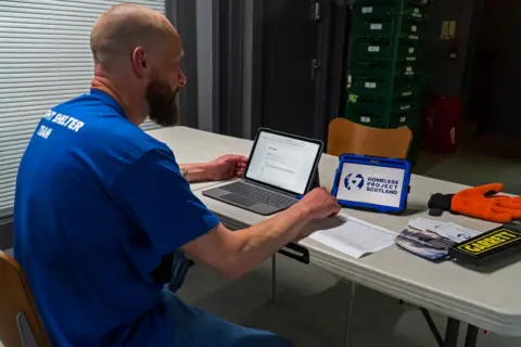 Homeless Project Scotland/Richard Hunt-Smith homeless project scotland worker at desk 