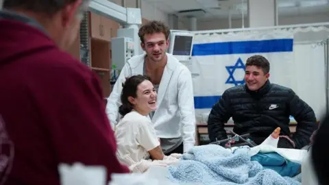 Israeli Prime Minister's Office/handout via Reuters Released hostage Itay Regev is reunited with his sister Maya Regev, another released hostage, shortly after his arrival in Israel after being released by Hamas in Gaza, at Soroka Medical Center in Beersheba, Israel (30 November 2023)