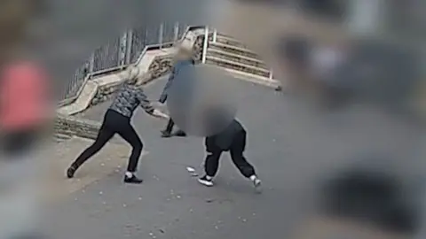 A still image of the moment a student attacked a teacher with a knife
