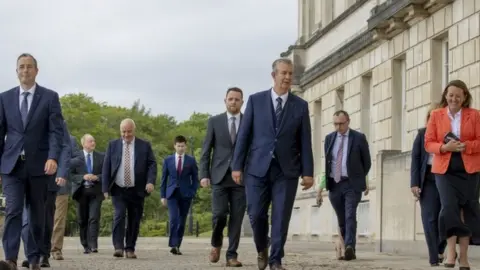 Press Association Edwin Poots with his ministerial team