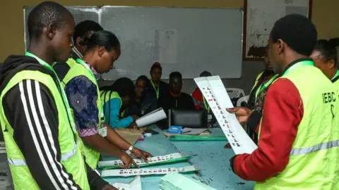 Getty Images IEBC officials at Nakuru school with voting forms