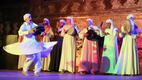 EPA Egyptians members of the "Tanoura Dance Troupe" perform at the Ghouri complex in Cairo, Egypt.