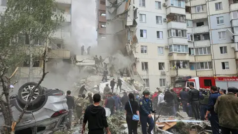 Reuters An apartment block partially collapsed