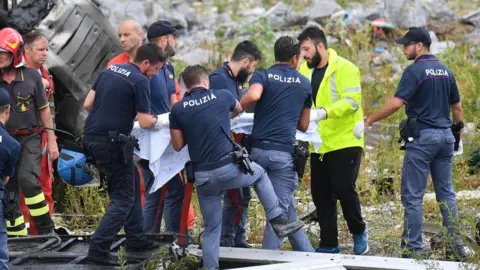 EPA Rescuers pull survivors of the Genoa bridge collapse from the debris