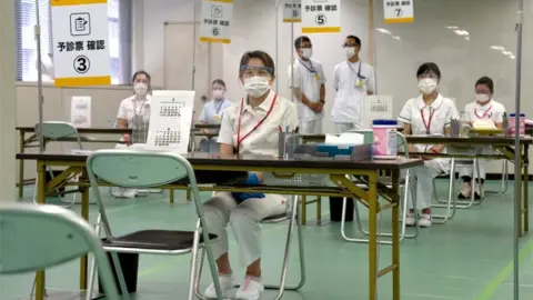 Reuters Nurses waiting for patients to arrive for their vaccinations