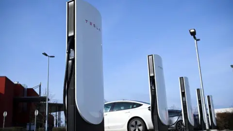 Reuters A Tesla electric vehicle charging station
