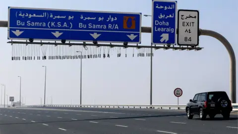 EPA Vehicles drive on road leading to Qatar's land border crossing with Saudi Arabia at Abu Samrah (6 January 2021)