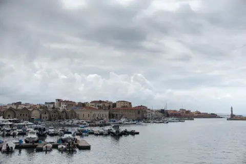 BBC View from the port of Chania, where Ahmed Tarzalakis and his family currently live.