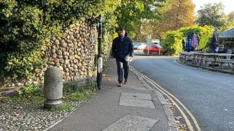 Qays Najm/BBC Stuart Worby arrives at Norwich Crown Court wearing a black puffer jacket, black trousers and brown shoes