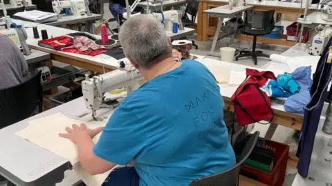 Suzanne sewing in HMP Downview's Making for Change workshop 