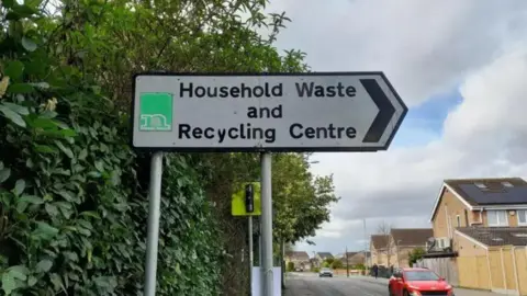 A sign which reads Household Waste and Recycling Centre. 