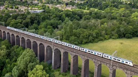 Getty Images Aerial view of a train travelling over The Digswell Viaduct