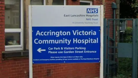 Google Close-up image of a blue and white sign, indicating Accrington Victoria Community Hospital