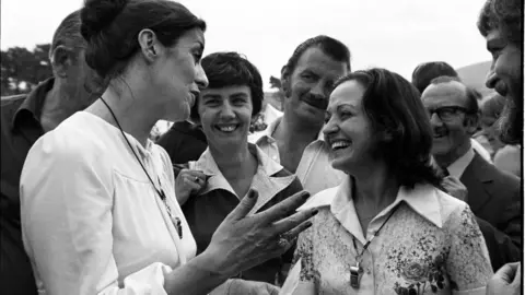 Getty/Alex Bowie/Contributor Betty Williams (left) and Mairead Corrigan, co-founders of the Community of Peace People and joint winners of the 1976 Nobel Peace Prize, lead a peace rally of Catholic and Protestant women on the Protestant Shankill Road, Belfast, 28th August 1976. Earlier that month, Williams had witnessed the deaths of three children in sectarian violence, and founded the Women For Peace (later the Community of Peace People) with Corrigan, the children's aunt. (Photo by Alex Bowie/Getty Images)