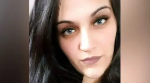 Handout A selfie of Daniela with dark brown hair looking directly into the camera