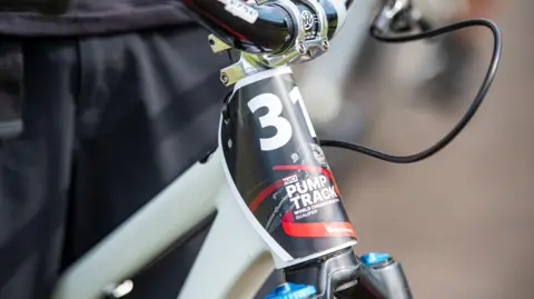 Pete Scullion A bike handlebar with the number 31 on the front