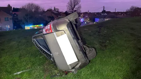 A car on its side in Guyhirn