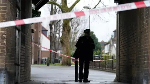 Police man standing in a street passageway 