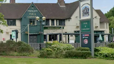 Google The dark and light green Waggon and Horses from the road with green grass and shrubs in front of it