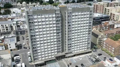 Eddie Mitchell St James House which is a gray 15 storey building with a white frontage and balconies