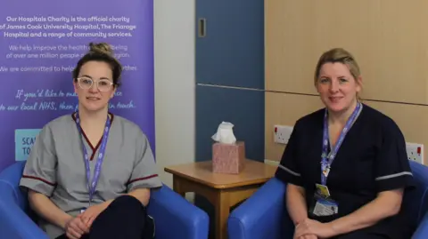 Francesca McDougall and Tracy Pickersgill, who leads bereavement services at the trust, sitting on two small blue armchairs. They are both dressed in scrubs and have lanyards with ID badges around their necks.