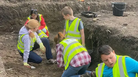 Swansea University School pupils help excavate land to the west of Margam Abbey Church as part of the ArchaeoMargam project