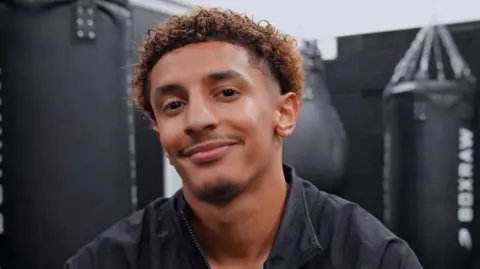 Saad Abdullah smiling towards the camera