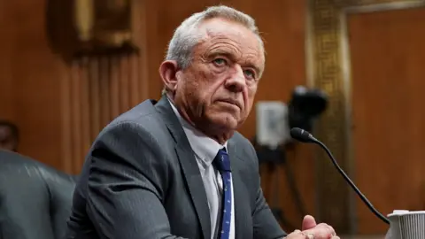 Robert F Kennedy Jr in front of a microphone at a senate hearing last week