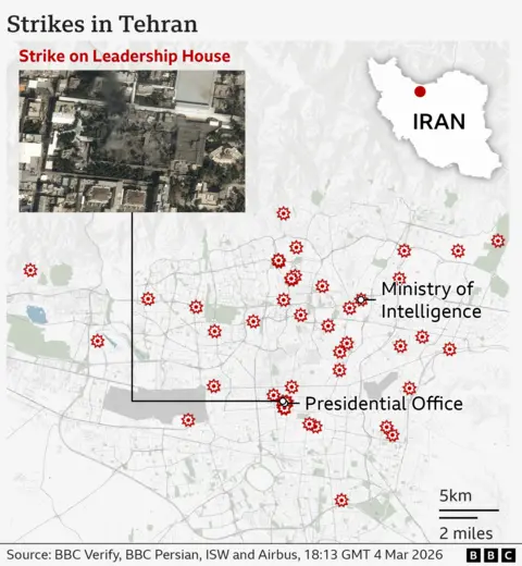 A detailed street‑map of Tehran showing several locations marked with red explosion‑style icons indicating strike sites. In the northern part of the city, one marker sits at the Ministry of Intelligence. Farther south, a cluster of markers indicates multiple strikes near the Presidential Office. To the east, there is another individual strike marker. A box in the upper left shows a satellite close‑up labelled “Strike on Leadership House,” depicting a damaged compound with dark blast marks and surrounding buildings